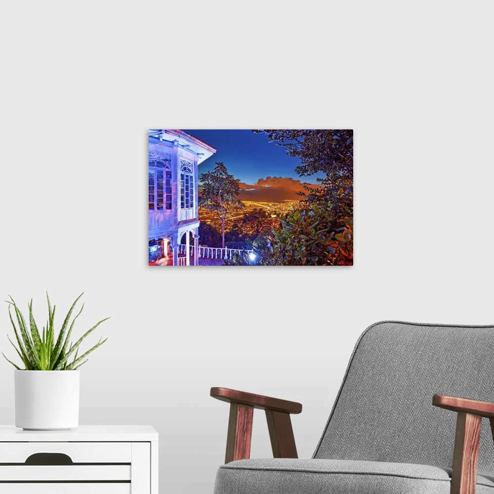 A modern room featuring Colombia, Bogota, night scene from Monserrate hill