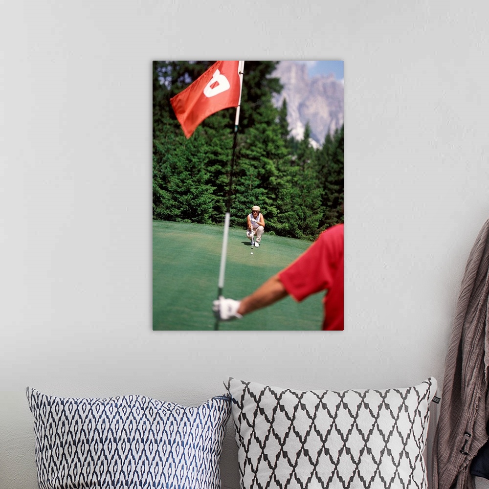 A bohemian room featuring Couple playing golf, man holding flag