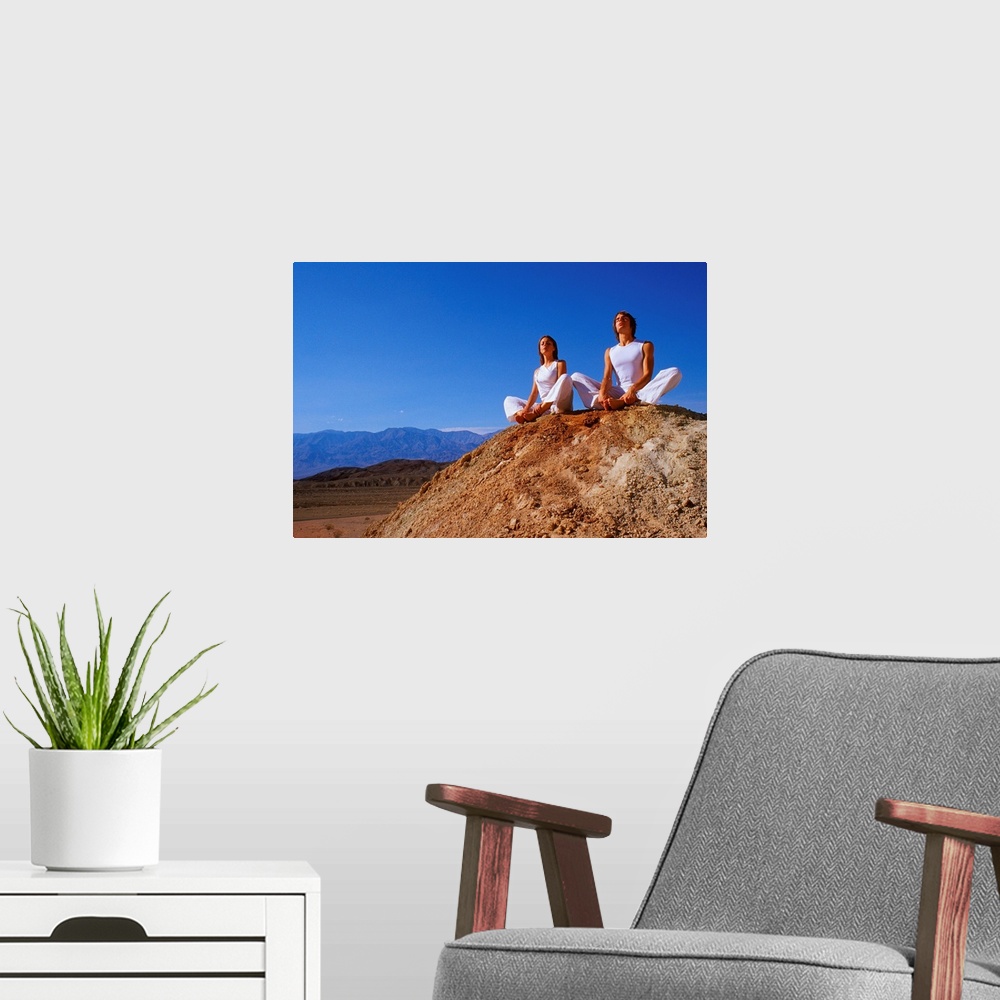 A modern room featuring Couple sitting on rock, meditating