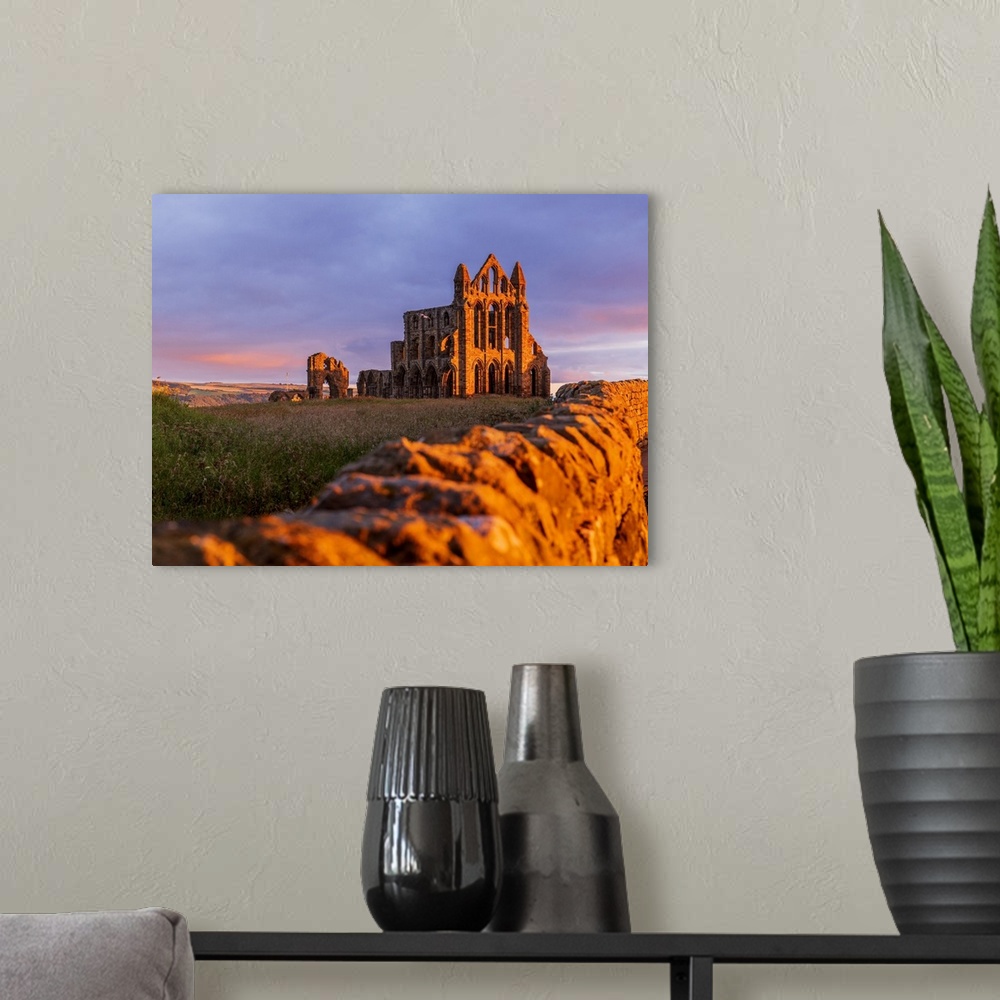 A modern room featuring England, North Yorkshire, Whitby, Great Britain, British Isles, Sunrise over the gothic ruins of ...