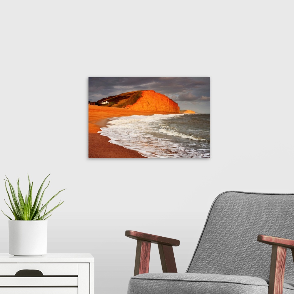 A modern room featuring English Channel, Dorset, View of the red limestone cliffs at West Bay, near Bridport
