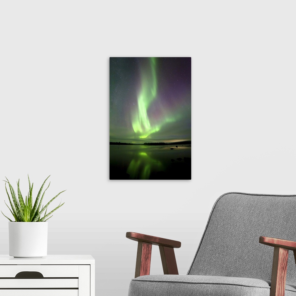 A modern room featuring Finland, Lapland, Scandinavia, Northern lights reflected in the lake, near Kaaresuvanto.