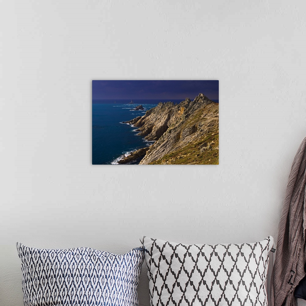 A bohemian room featuring A storm approaching the cliffs at Pointe du Raz, with the famous lighthouse out in the Atlantic o...