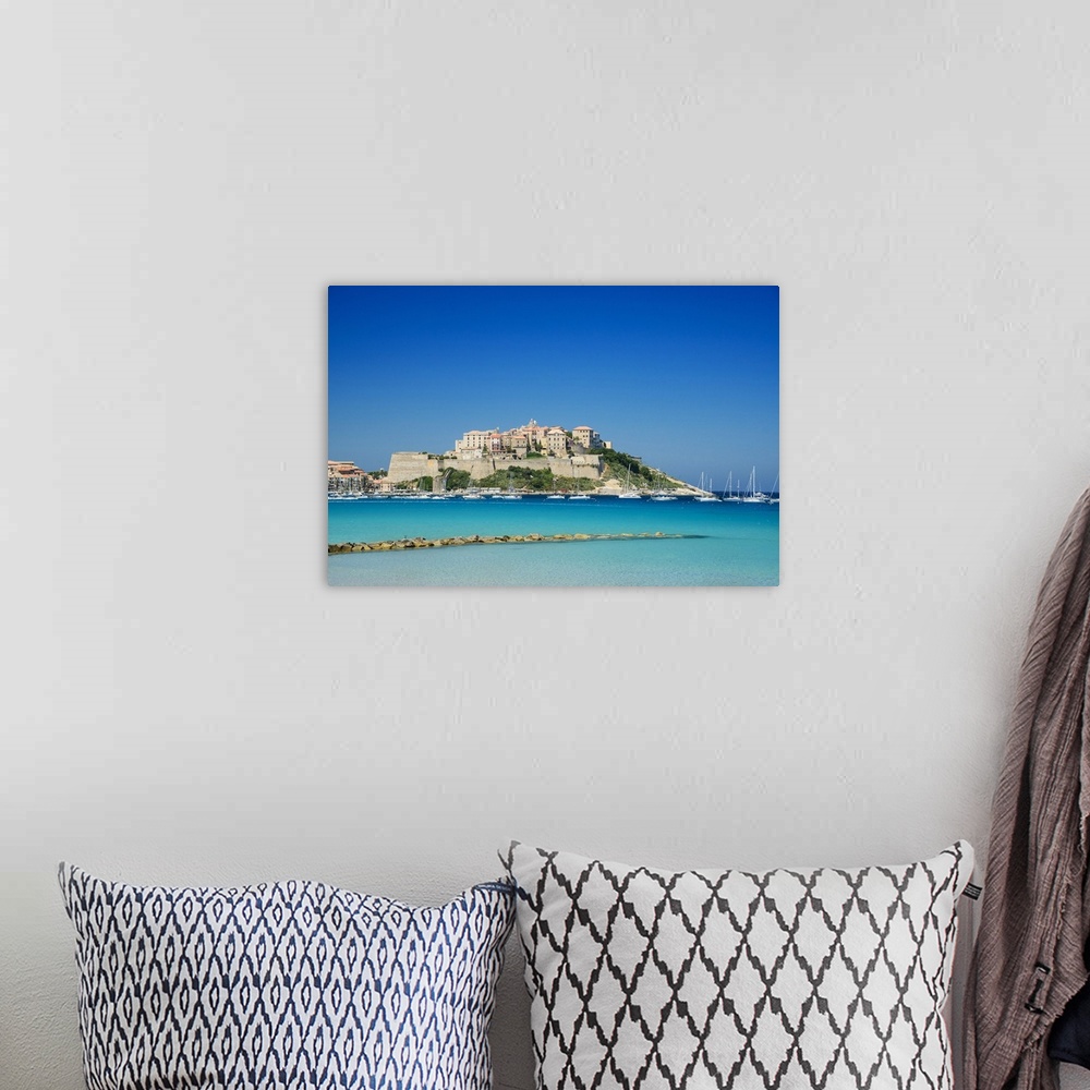 A bohemian room featuring France, Corsica, Mediterranean sea, Calvi, Citadel, view from the beach.
