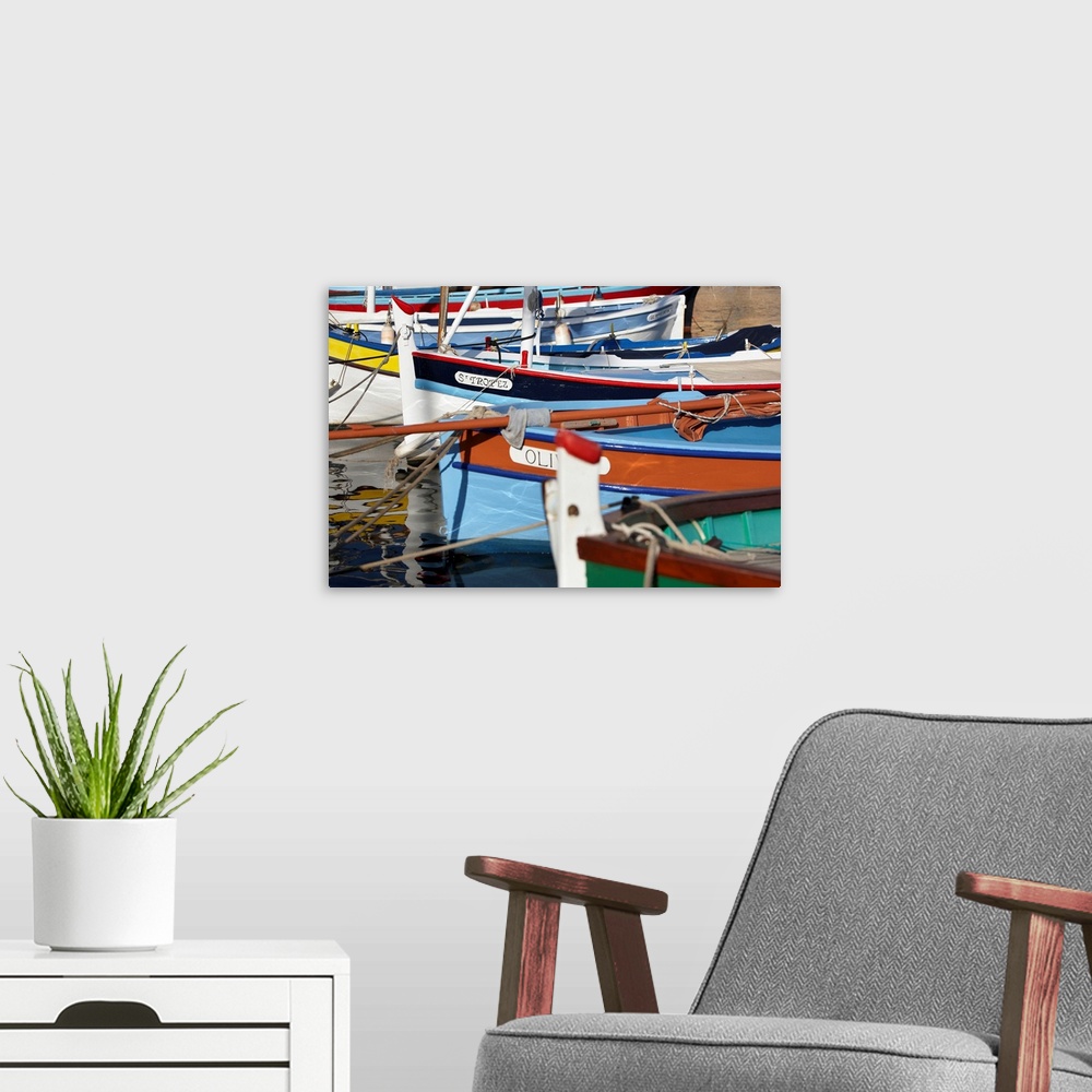 A modern room featuring France, Cote d'Azur, Saint-Tropez, Traditional fishing boats in the harbor.