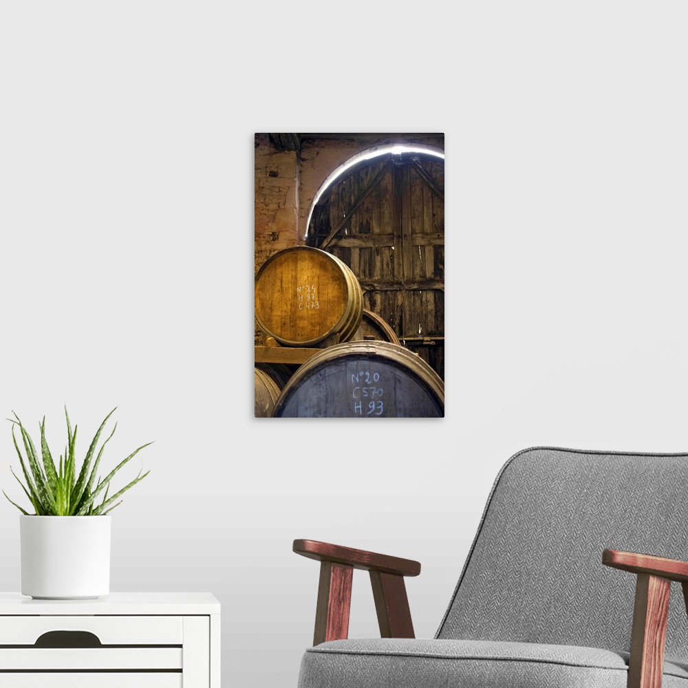A modern room featuring France, Normandy, Calvados barrels in the cellar