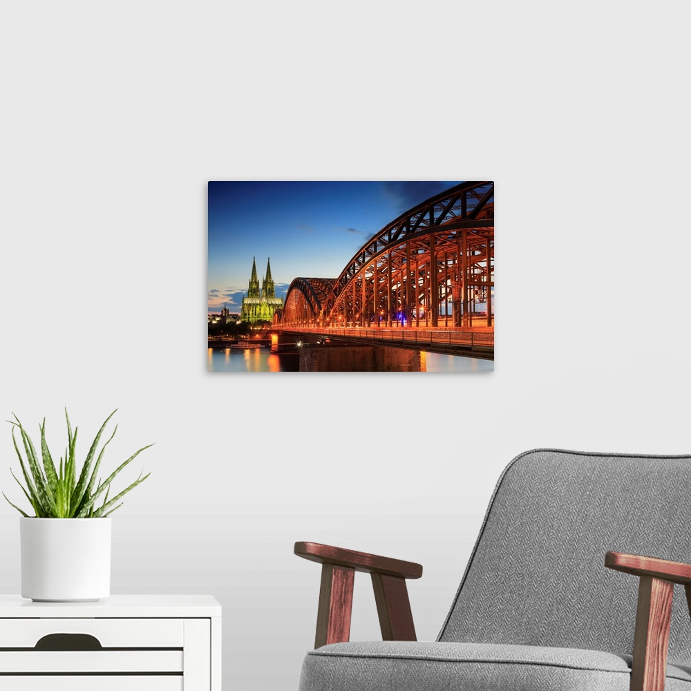 A modern room featuring Germany, North Rhine-Westphalia, Cologne, Cologne Cathedral and Hohenzollern Bridge in the evening.