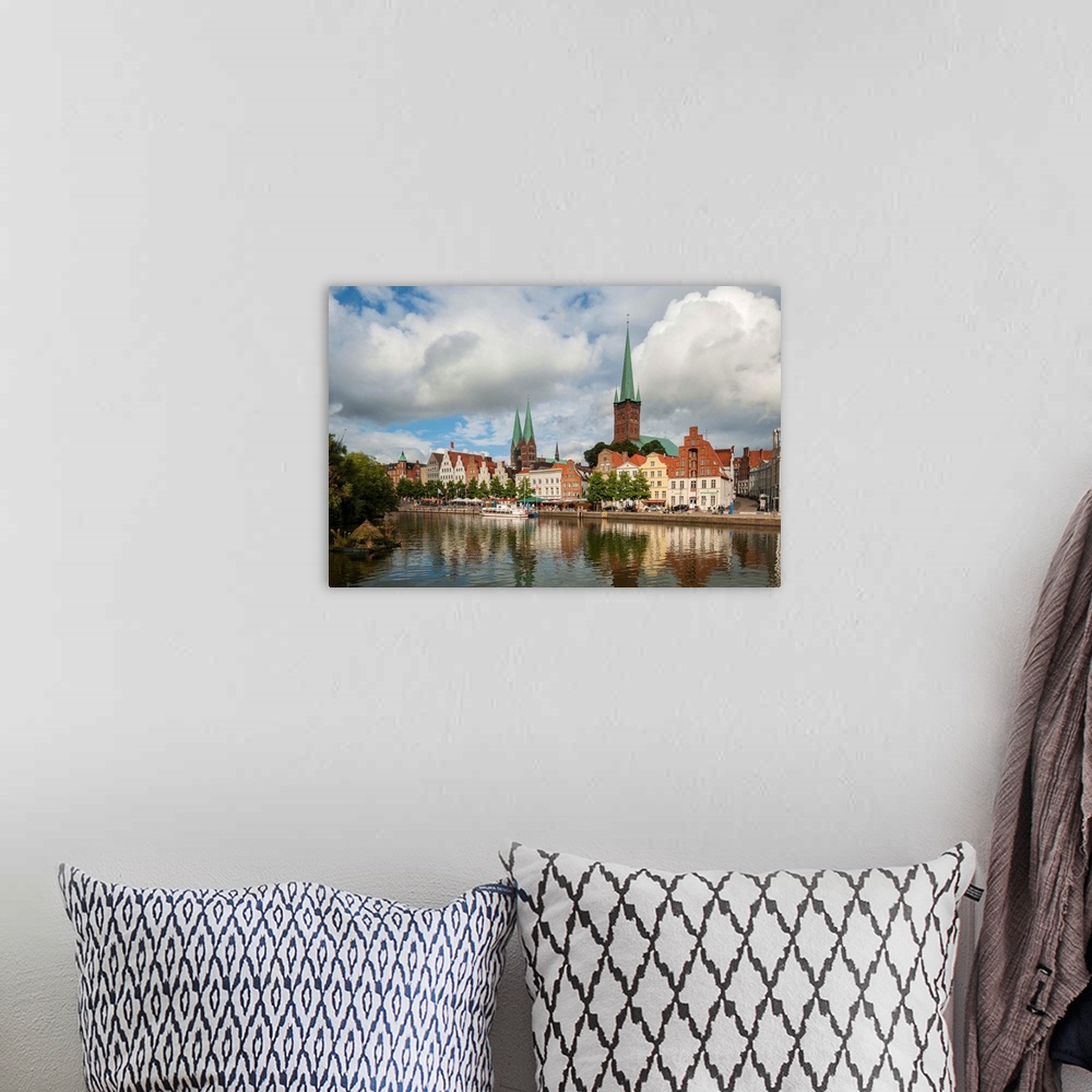 A bohemian room featuring Germany, Schleswig-Holstein, Lubeck, Petrikirche from Fussgangerbrucke on Trave Canal.
