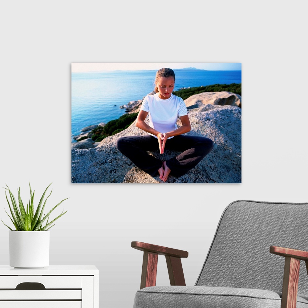 A modern room featuring Girl meditating on rock