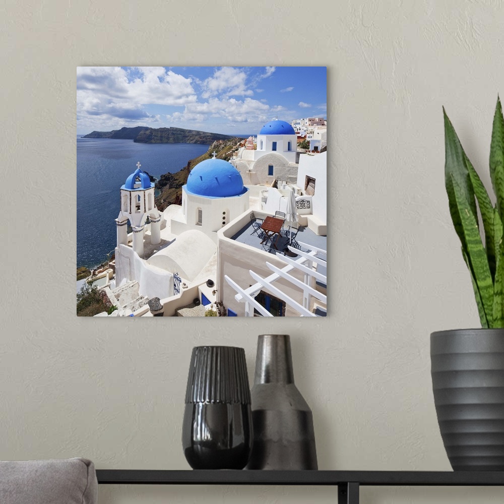 A modern room featuring Greece, Aegean islands, Cyclades, Santorini island, Greek Islands, Oia village, typical church.