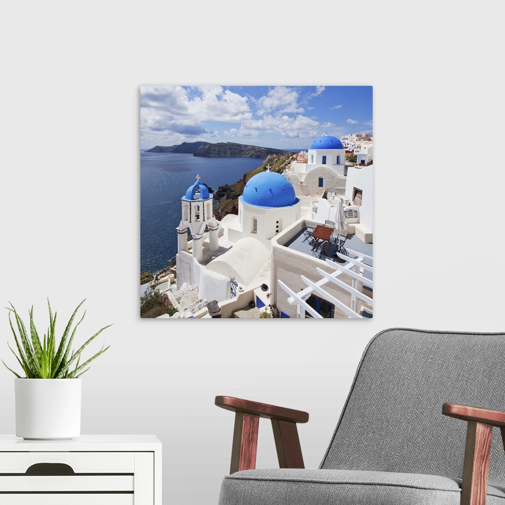 A modern room featuring Greece, Aegean islands, Cyclades, Santorini island, Greek Islands, Oia village, typical church.
