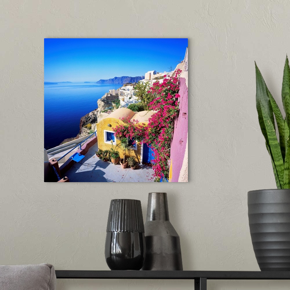 A modern room featuring Greece, Aegean islands, Cyclades, Santorini island, Thera, Oia, traditional houses and the crater