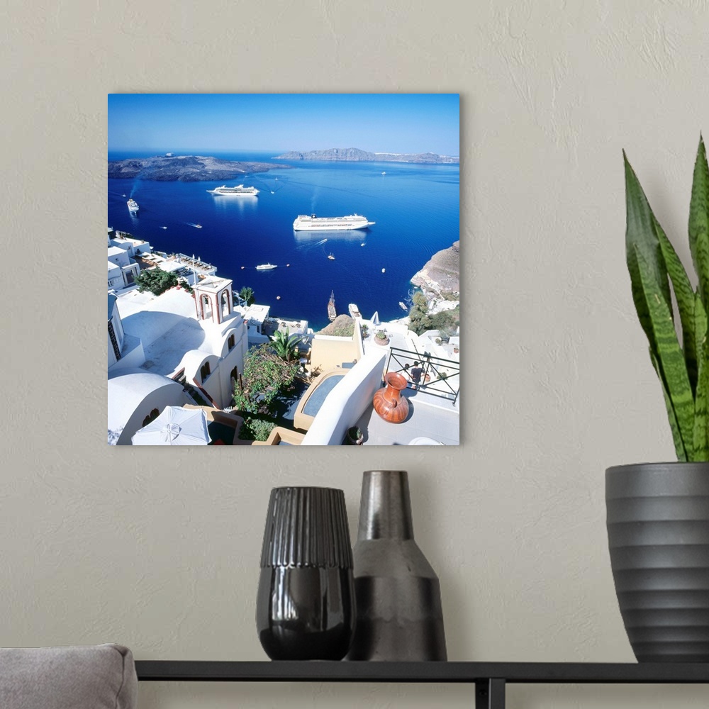 A modern room featuring Greece, Aegean islands, Santorini, Fira, view towards cruise ships in the crater