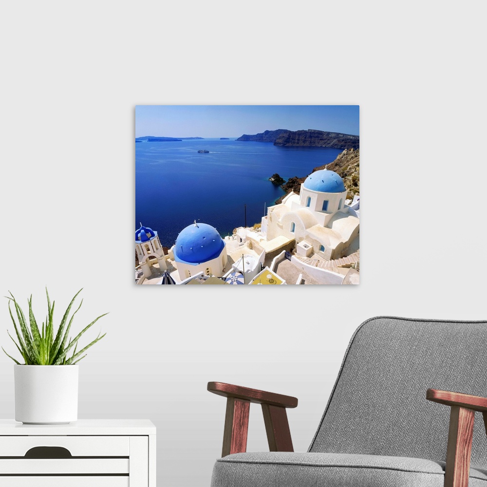 A modern room featuring Greece, Cyclades, Santorini, Oia, view towards the sea