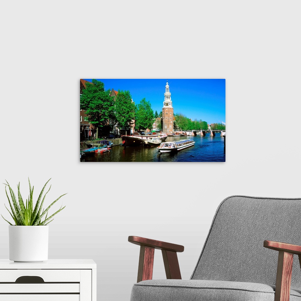 A modern room featuring Holland, Amsterdam, Montelbaanstoren, cruise boat along canal