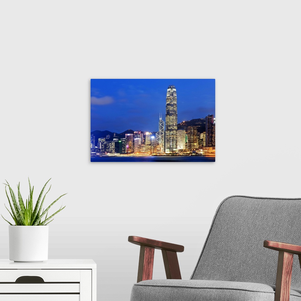 A modern room featuring China, Hong Kong, Hong Kong island, City skyline illuminated at night with International Finance ...
