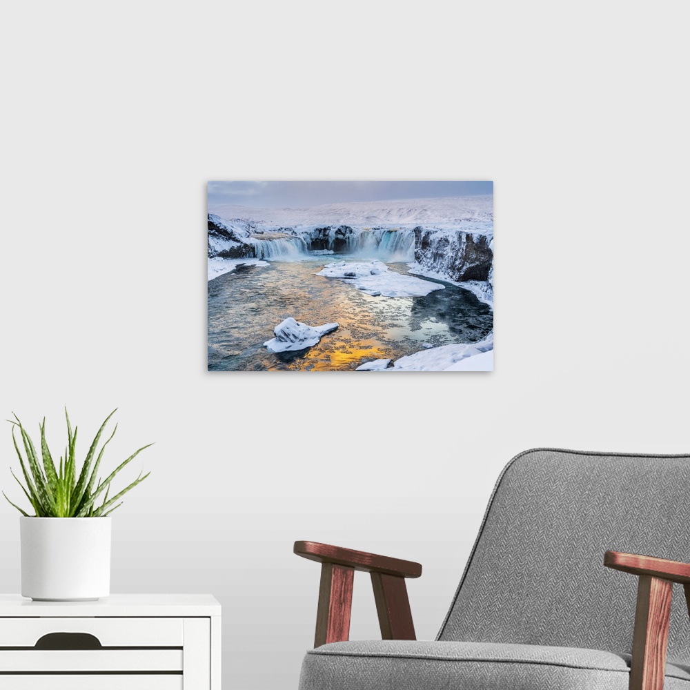 A modern room featuring Iceland, Northeast Iceland, Sunset over a snow-covered Godafoss.