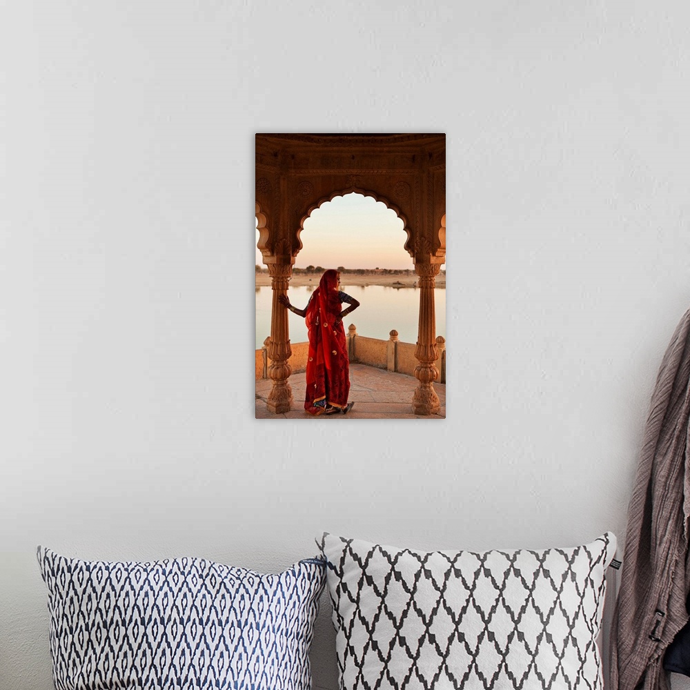 A bohemian room featuring India, Rajasthan, Jaisalmer, Gadi Sagar lake, Woman wearing a sari on the lake.