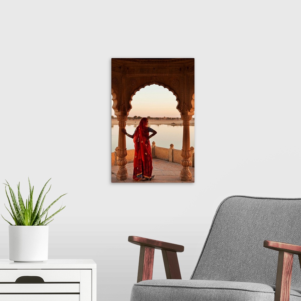 A modern room featuring India, Rajasthan, Jaisalmer, Gadi Sagar lake, Woman wearing a sari on the lake.
