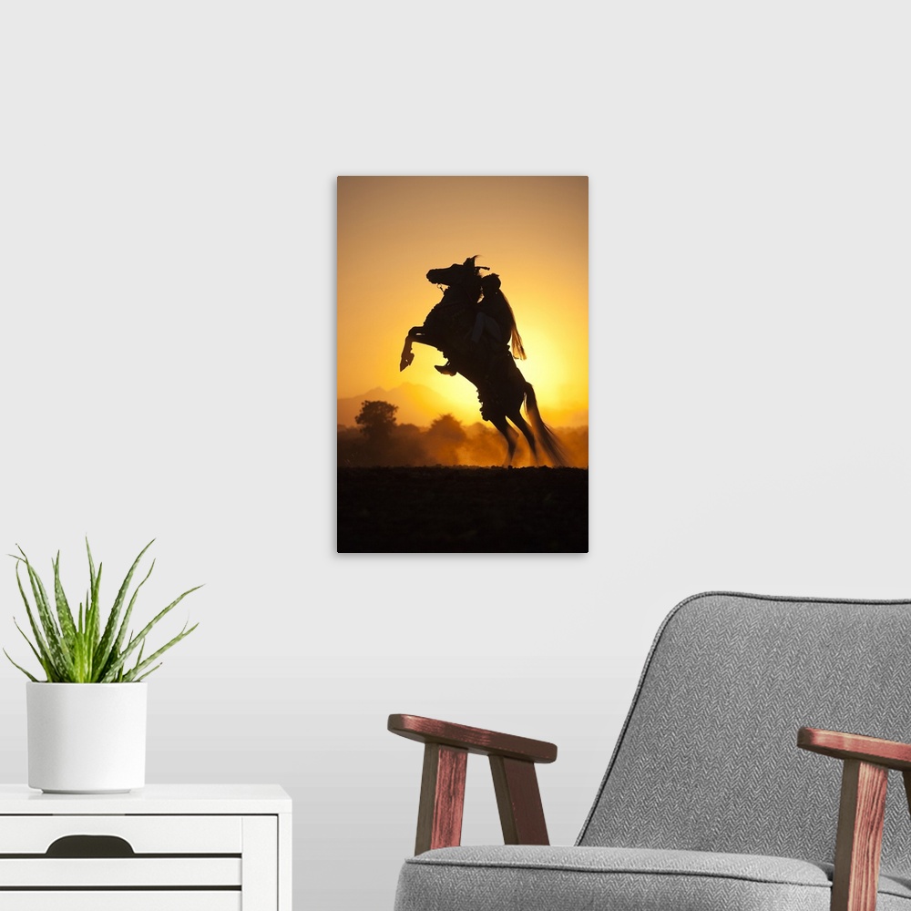 A modern room featuring India, Rajasthan, A typically dressed rider on a rearing Kathiawari horse backlit in the sunset