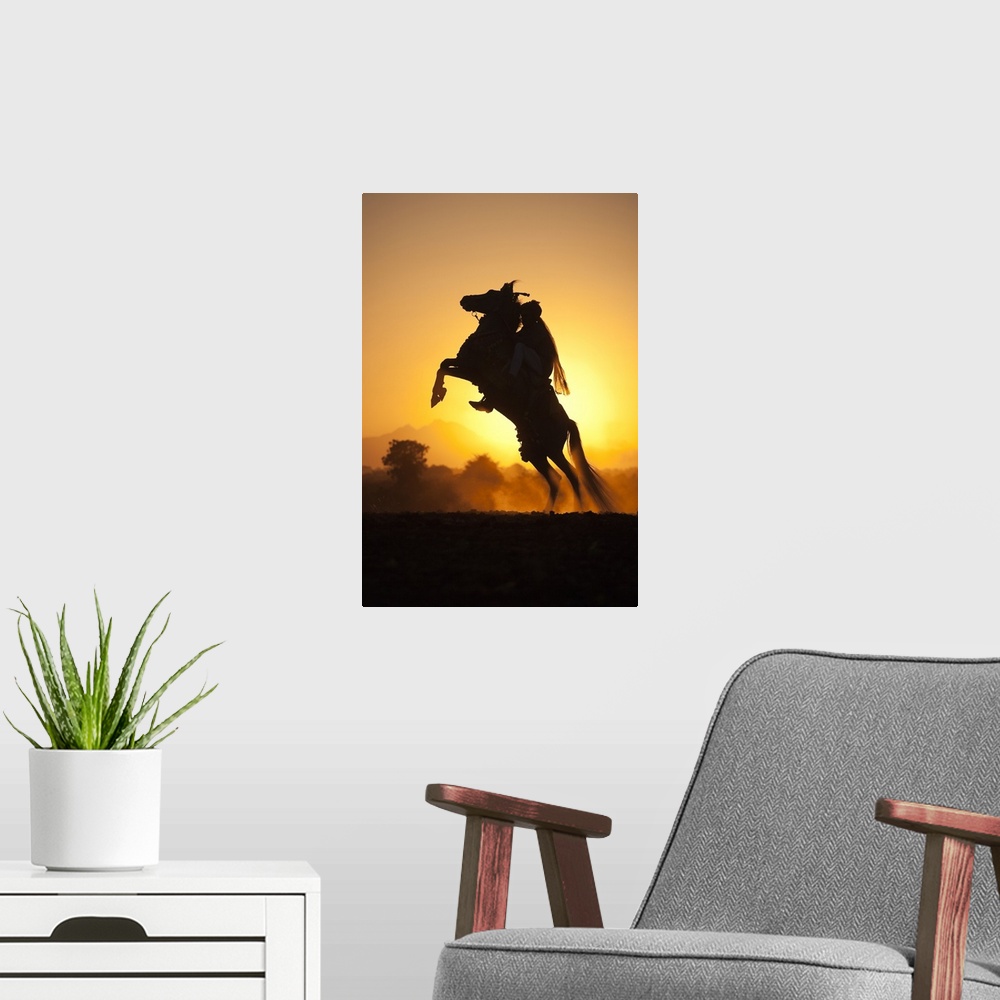 A modern room featuring India, Rajasthan, A typically dressed rider on a rearing Kathiawari horse backlit in the sunset