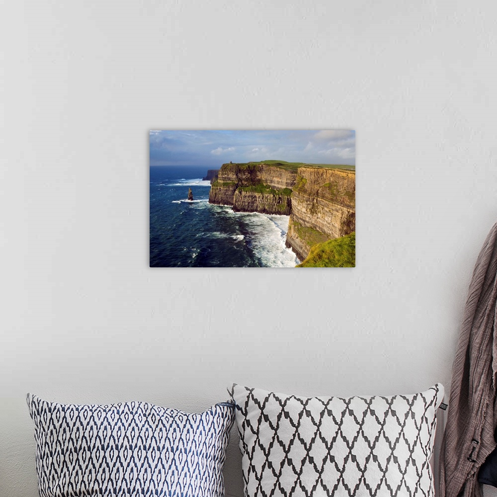 A bohemian room featuring Ireland, Clare, waves generated by Atlantic Ocean storms pound base of Cliffs of Moher
