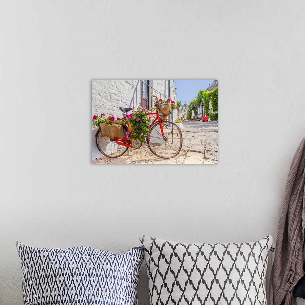 A bohemian room featuring Italy, Apulia, Bari district, Itria Valley, Alberobello, Bicycle in a typical street of Alberobello.