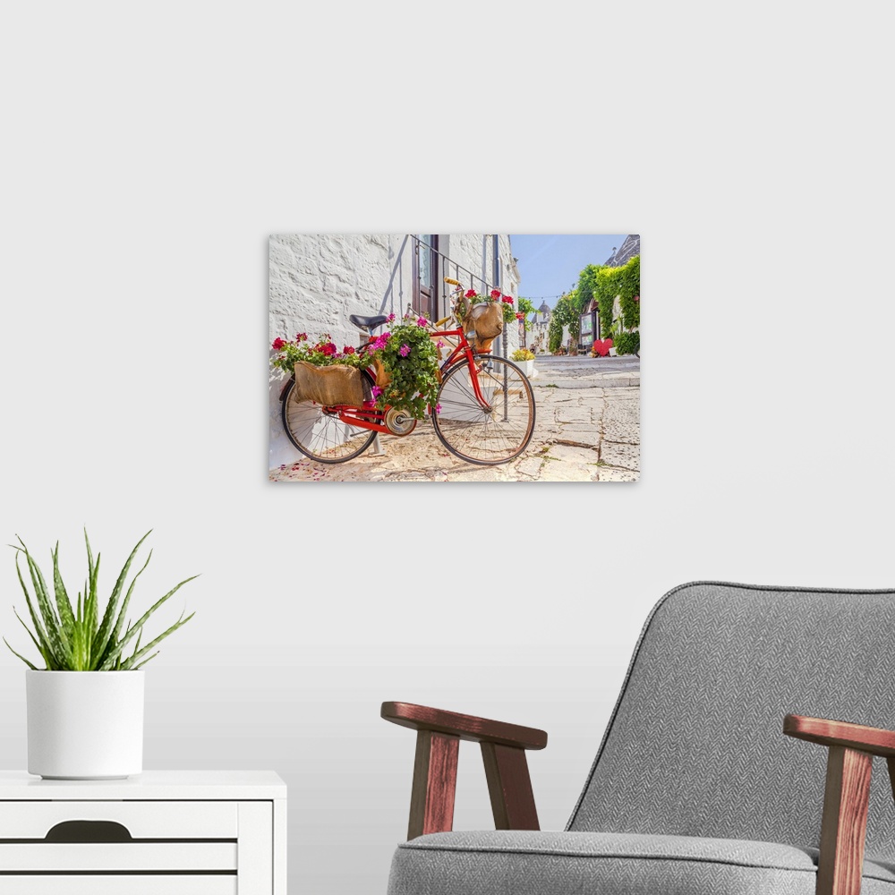 A modern room featuring Italy, Apulia, Bari district, Itria Valley, Alberobello, Bicycle in a typical street of Alberobello.