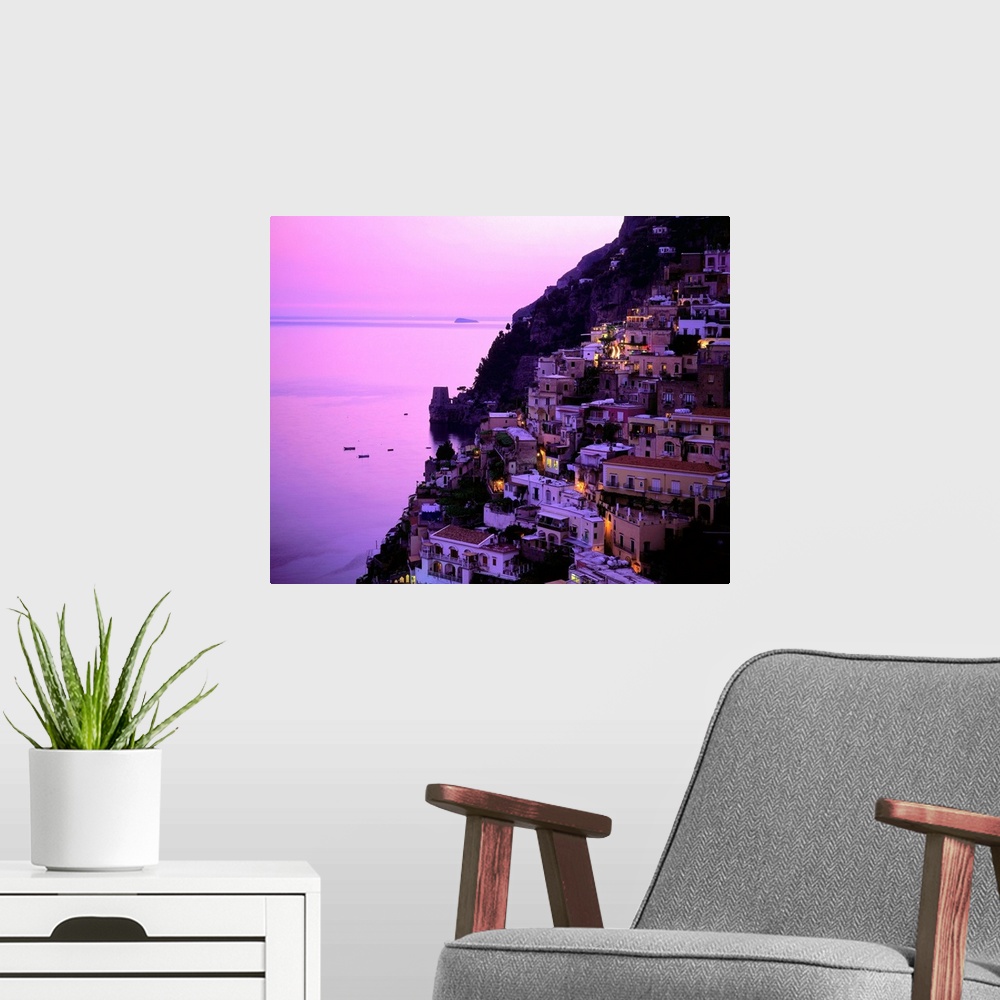 A modern room featuring Italy, Campania, Positano, Amalfi coast, view over town at dusk
