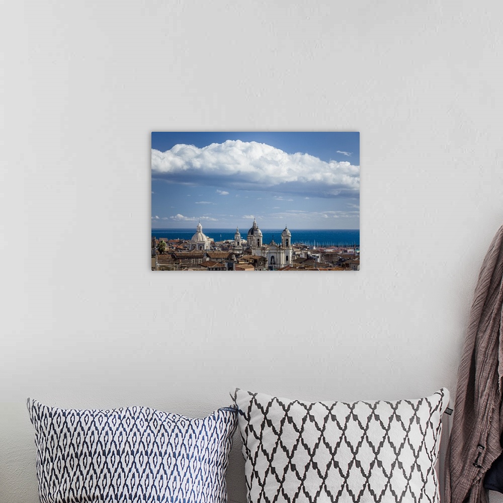 A bohemian room featuring Italy, Sicily, Mediterranean area, Catania district, Catania, View of the sea and baroque domes.