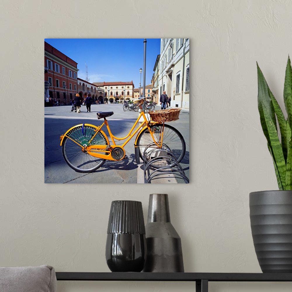 A modern room featuring Italy, Emilia Romagna, Ravenna, Piazza del Popolo, bicycle locked to rack