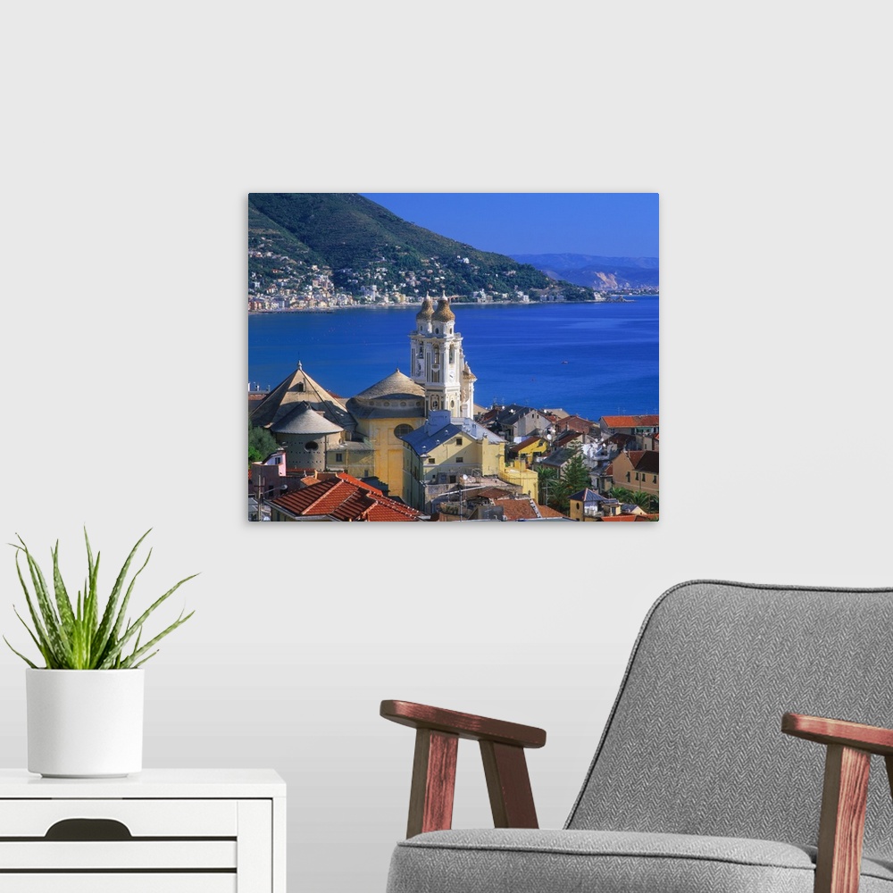 A modern room featuring Italy, Liguria, Laigueglia, view towards old town and the San Matteo church