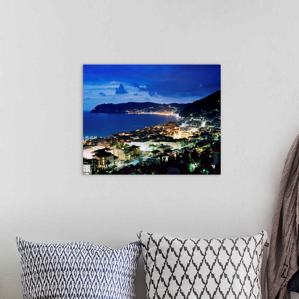 A bohemian room featuring Italy, Liguria, Riviera di Ponente, Alassio, view over the bay by night