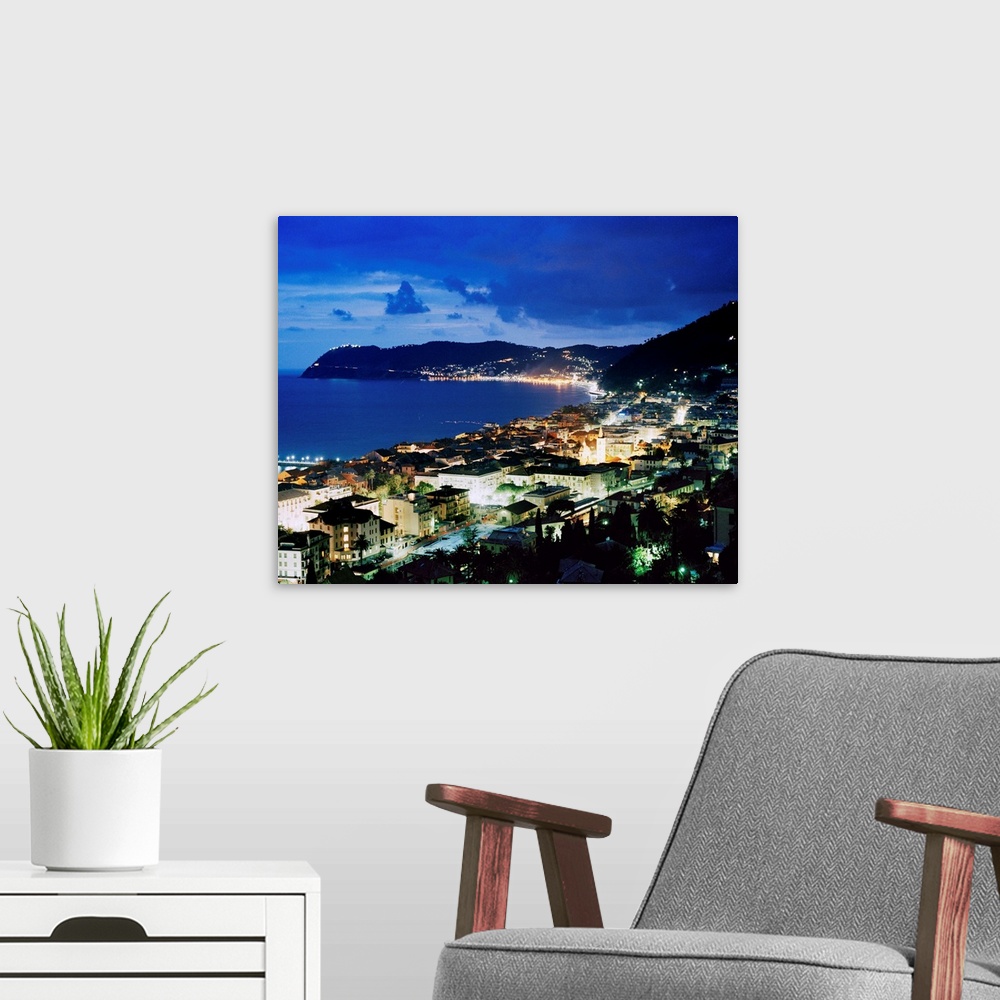 A modern room featuring Italy, Liguria, Riviera di Ponente, Alassio, view over the bay by night