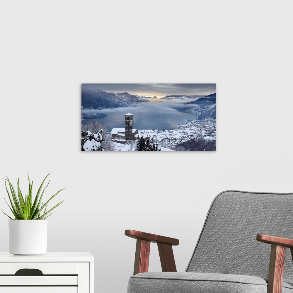 A modern room featuring Italy, Lombardy, Como Lake, Peglio, Sant'Eusebio church and the lake with snow