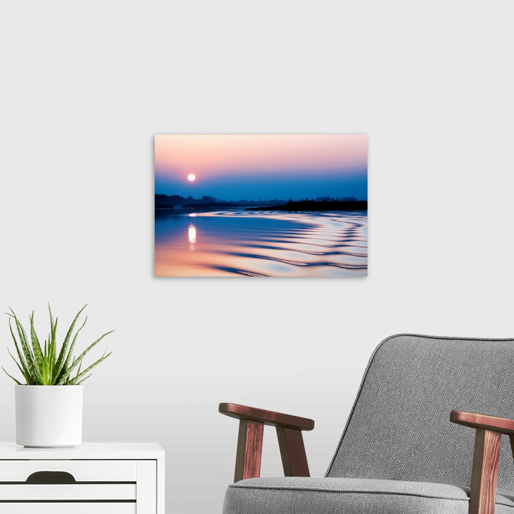 A modern room featuring Italy, Lombardy, Curtatone area, Mincio natural park, view of the lagoon at sunset.