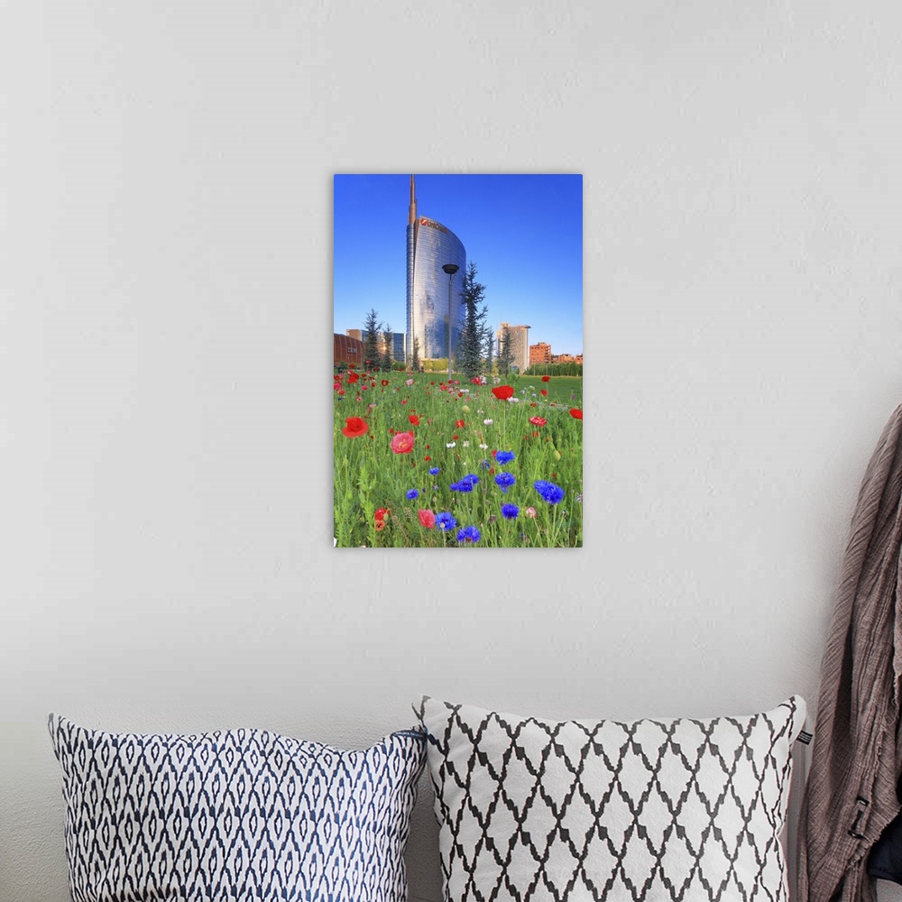 A bohemian room featuring Italy, Lombardy, Milano district, Milan, Porta Nuova, Flowers and the Unicredit Tower at dawn.