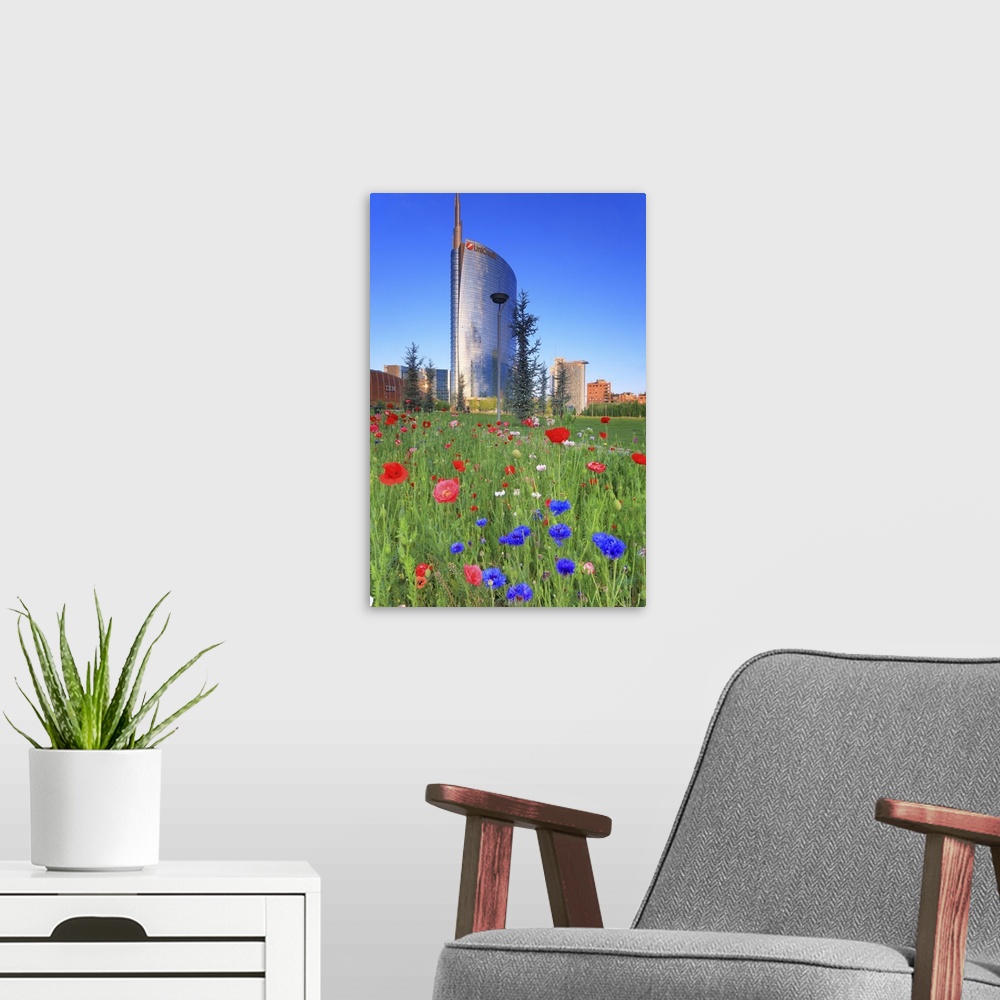 A modern room featuring Italy, Lombardy, Milano district, Milan, Porta Nuova, Flowers and the Unicredit Tower at dawn.