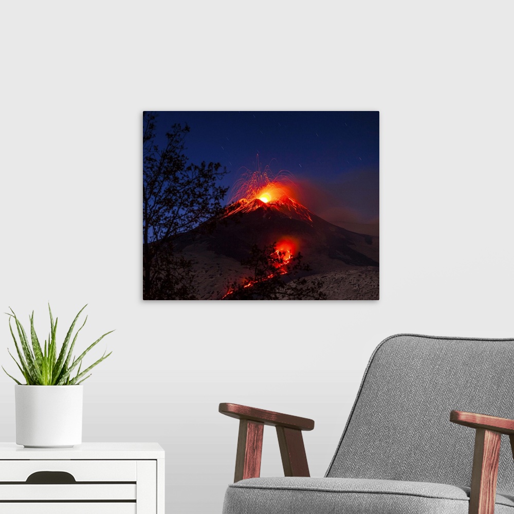 A modern room featuring Italy, Sicily, Catania district, Mount Etna, South-east crater eruption at night, lava flowing to...