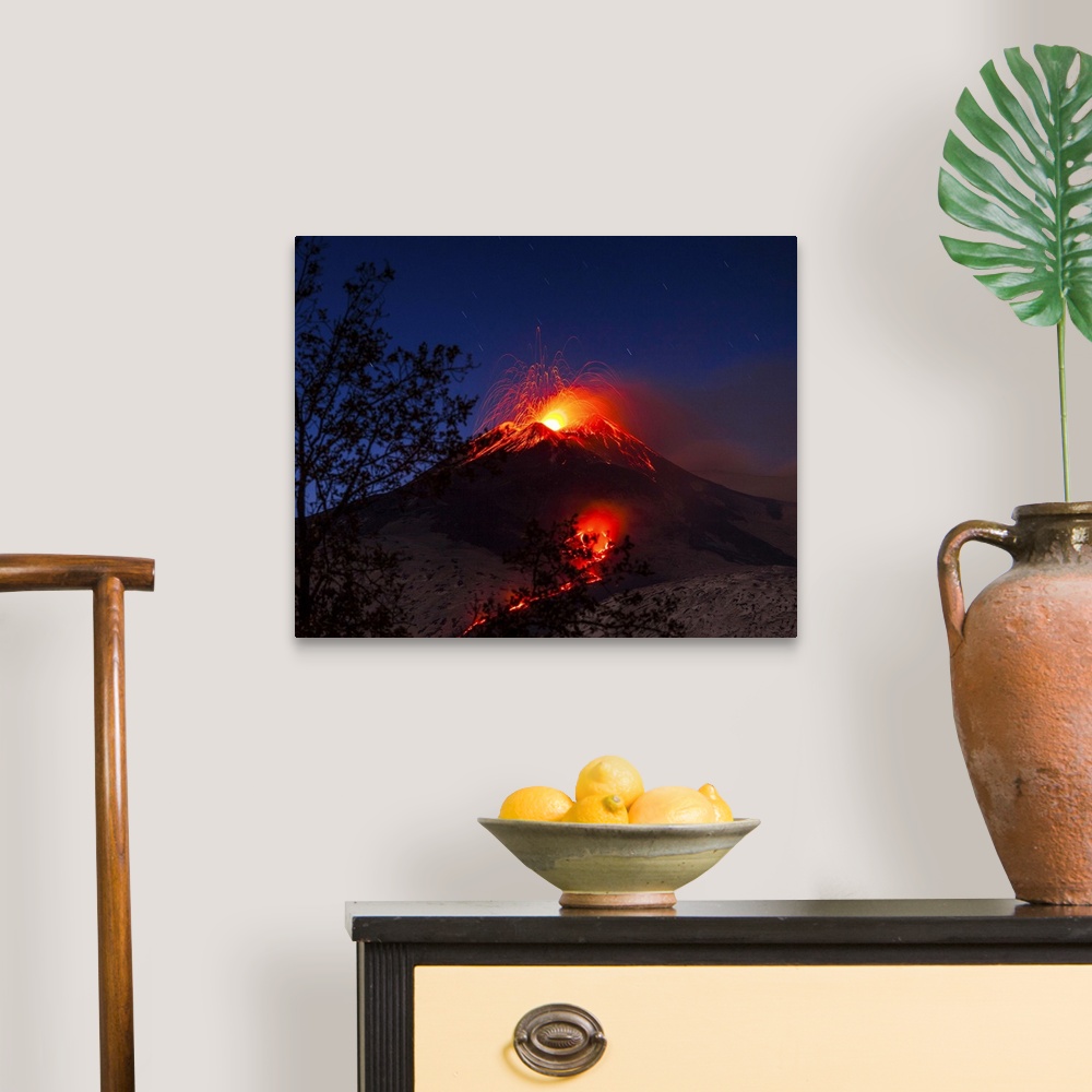 A traditional room featuring Italy, Sicily, Catania district, Mount Etna, South-east crater eruption at night, lava flowing to...