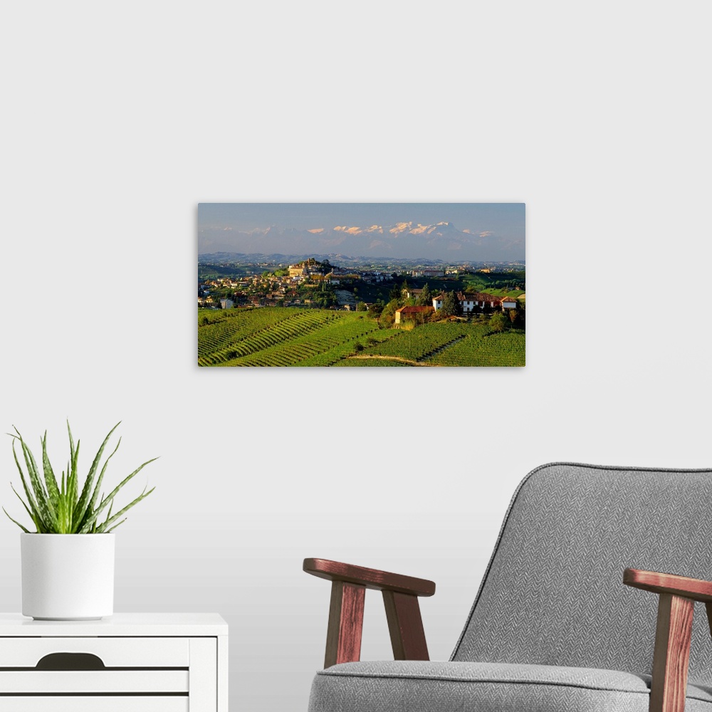 A modern room featuring Italy, Piedmont, Monferrato, Castagnole delle Lanze village and Monte Rosa in background