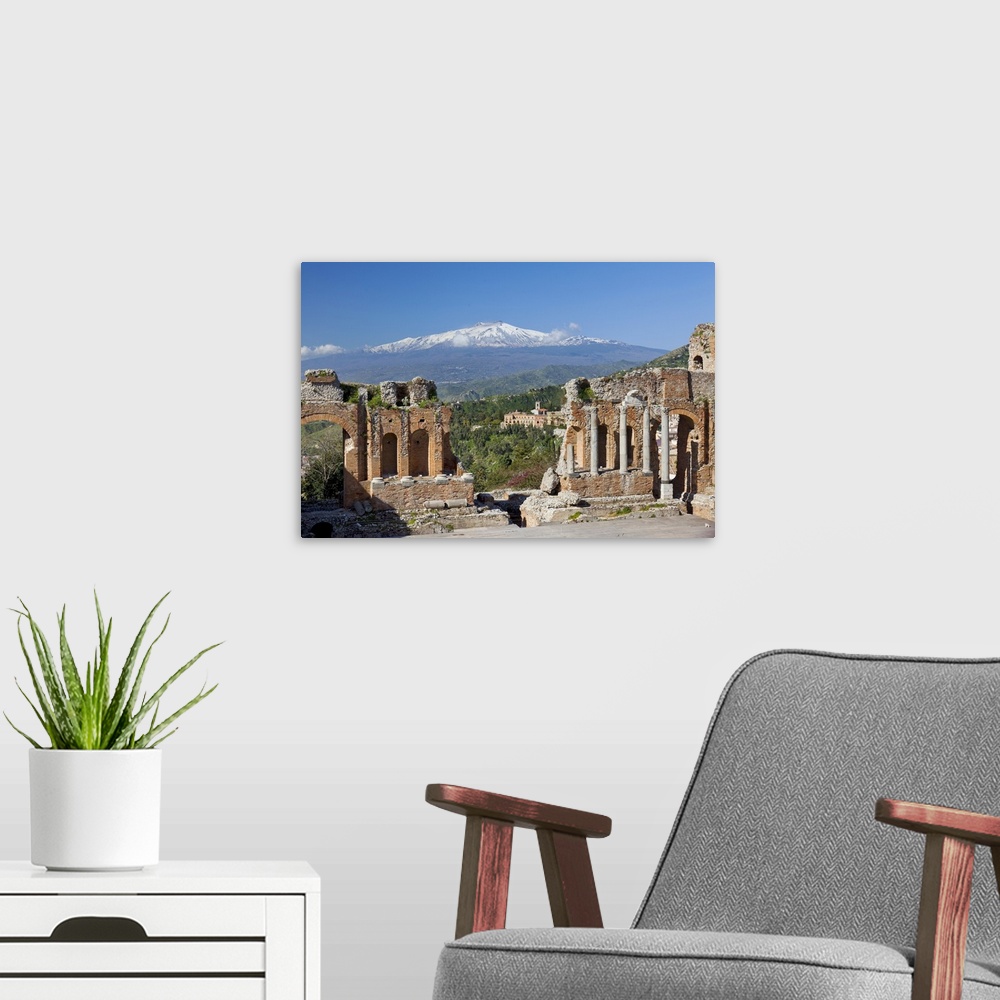 A modern room featuring Italy, Sicily, Messina district, Taormina, Greek theatre, Mount Etna in background