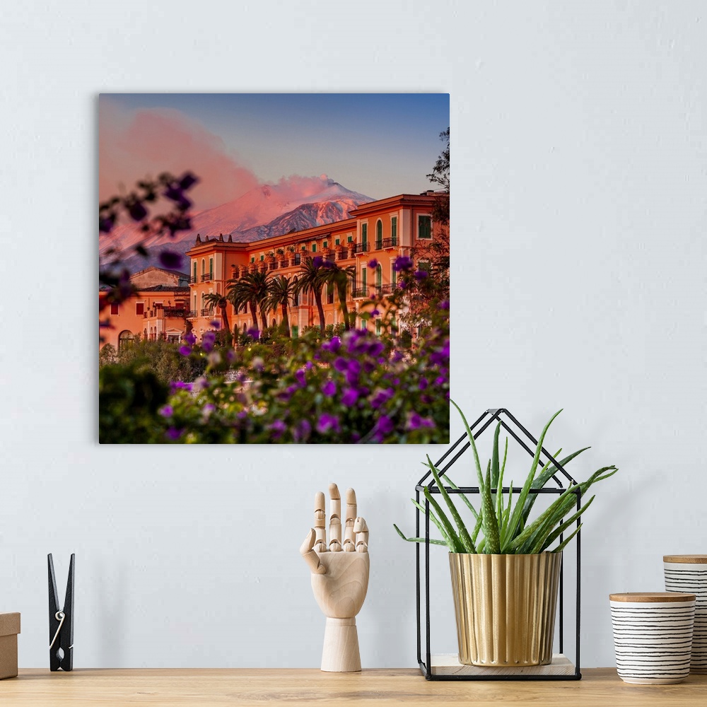 A bohemian room featuring Italy, Sicily, Messina district, Taormina, San Domenico Palace Hotel at sunset with Mount Etna in...