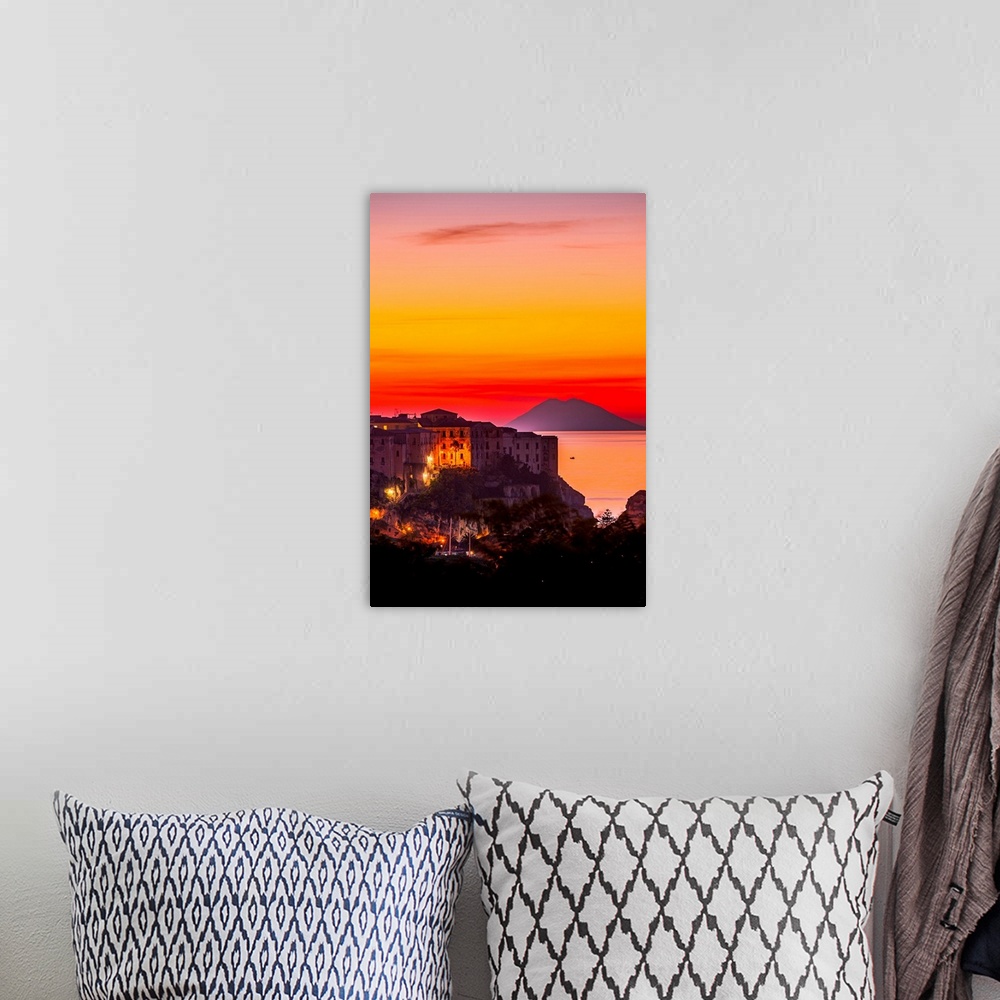 A bohemian room featuring Italy, Calabria, Mediterranean area, Vibo Valentia district, Tropea, Town at sunset with Strombol...