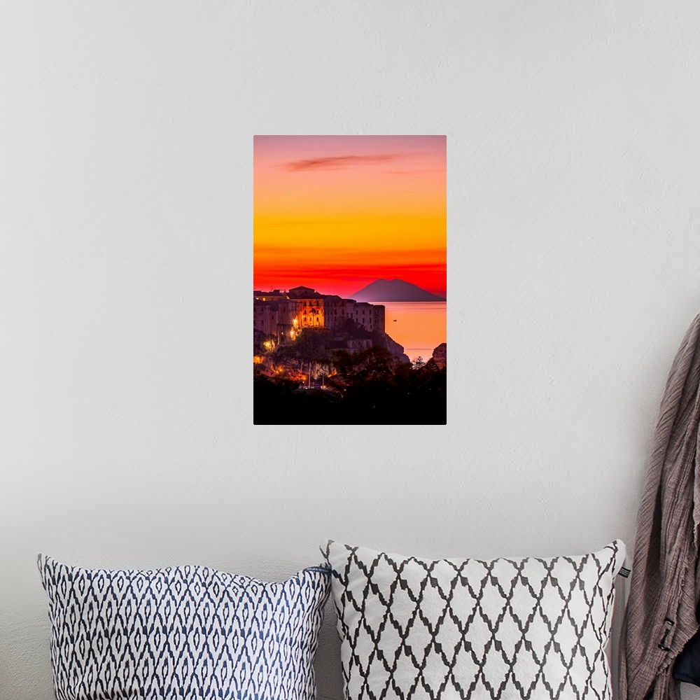 A bohemian room featuring Italy, Calabria, Mediterranean area, Vibo Valentia district, Tropea, Town at sunset with Strombol...
