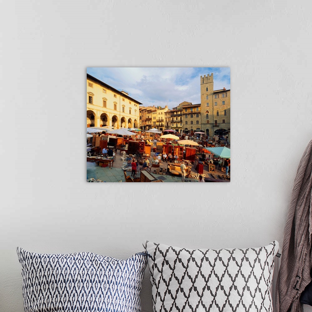 A bohemian room featuring Italy, Tuscany, Arezzo, Piazza Grande, antique trade market