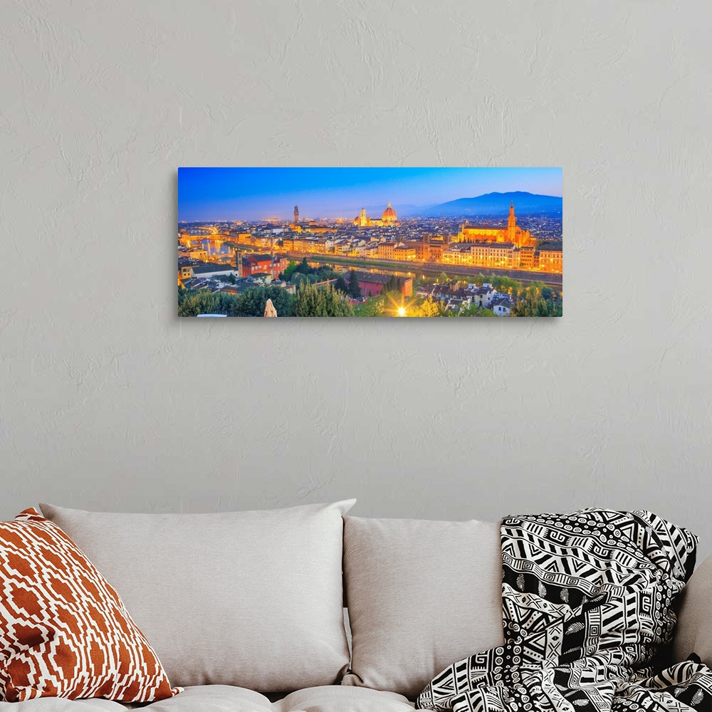 A bohemian room featuring Italy, Tuscany, Firenze district, Florence, City illuminated at dusk.