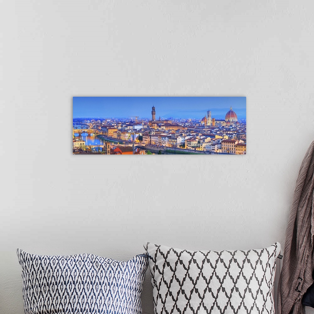 A bohemian room featuring Italy, Tuscany, Firenze district, Florence, City illuminated at dusk.