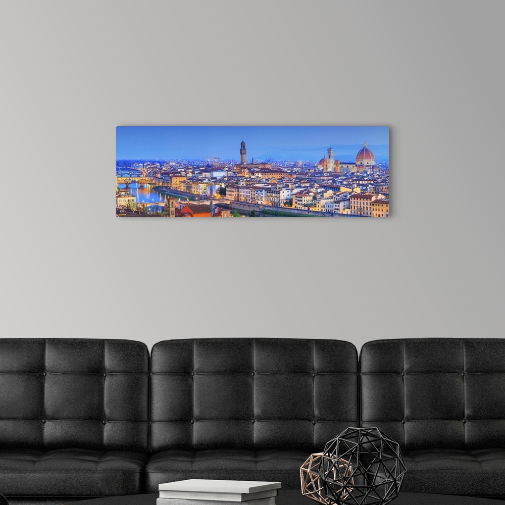 A modern room featuring Italy, Tuscany, Firenze district, Florence, City illuminated at dusk.
