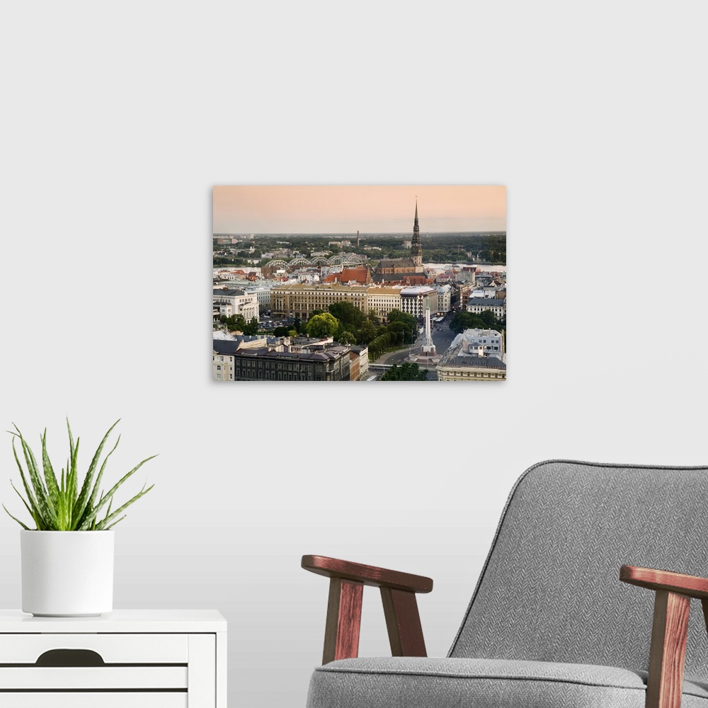 A modern room featuring Latvia, Riga, Cityscape with view of the Freedom Monument and St Peter's Church